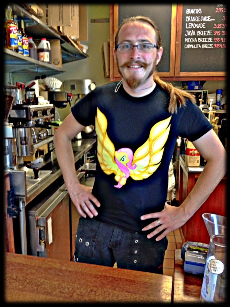A  twisted pony tail wearing Barista in a My Little Pony Tee shirt