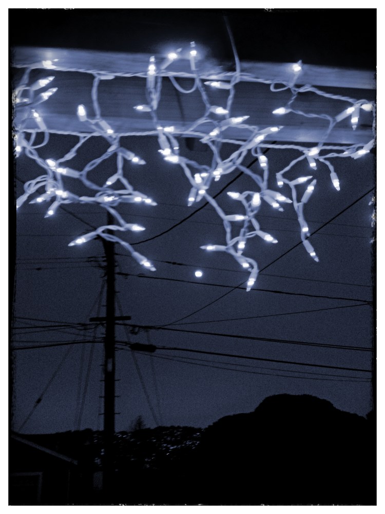 Looking at full moon  through lights 